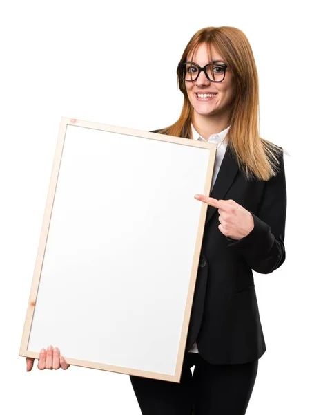 Young business woman holding an empty placard — Stock Photo, Image