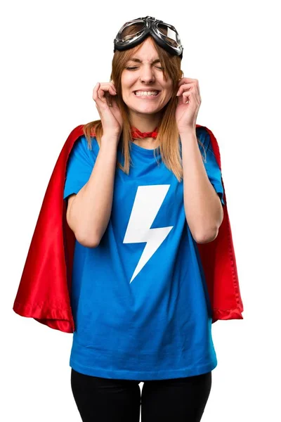 Pretty superhero girl covering her ears — Stock Photo, Image