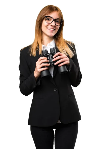 用双筒望远镜的年轻商业女人 图库图片