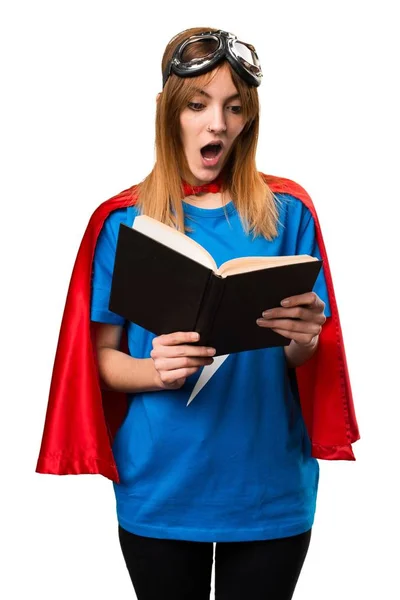 Pretty superhero girl reading book