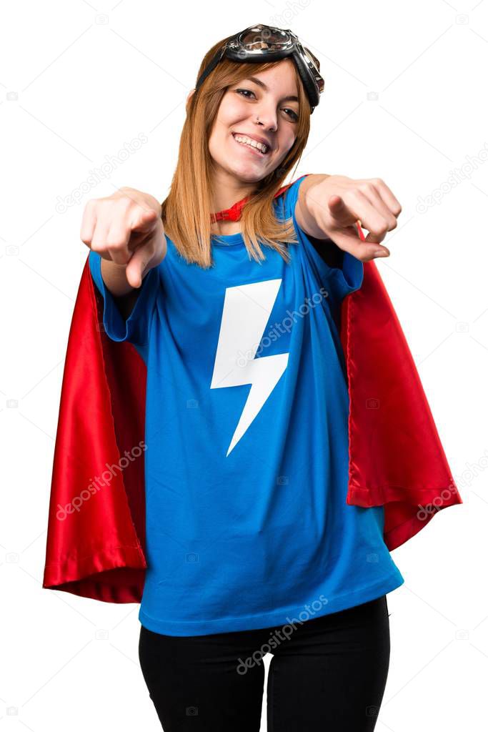 Pretty superhero girl pointing to the front