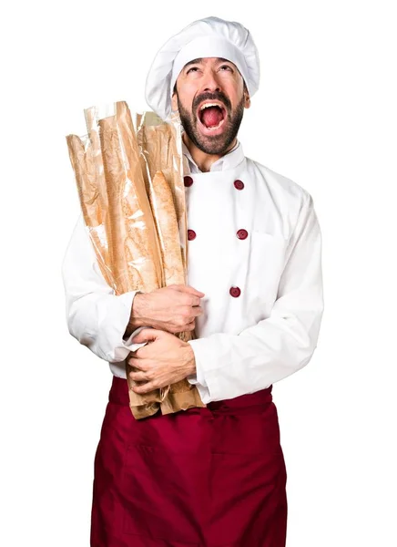 Młody piekarz trzyma chleb i krzyczy — Zdjęcie stockowe