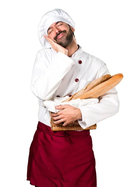 Młody piekarz trzyma chleb i Dokonywanie sen gest — Zdjęcie stockowe