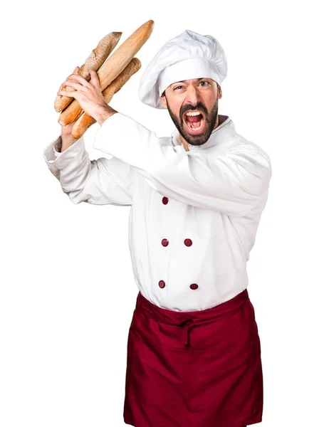 Jeune boulanger frustré tenant du pain — Photo