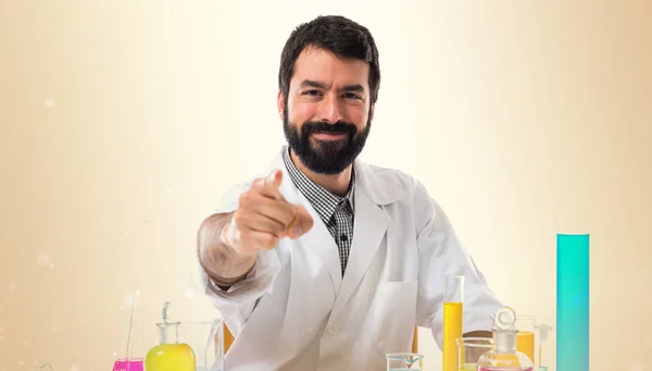 Scientist man pointing to the front on ocher background — Stock Photo, Image