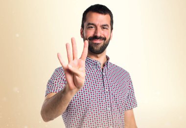 Yakışıklı adam dört koyu sarı zemin üzerine sayma
