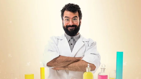 Scientist man with his arms crossed on ocher background — Stock Photo, Image