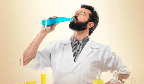 Scientist man with test tubes on ocher background — Stock Photo, Image