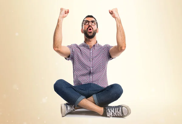 Hombre afortunado con gafas sobre fondo ocre —  Fotos de Stock