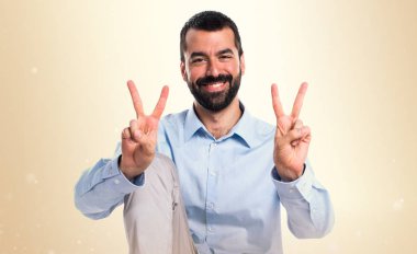 Zafer jest koyu sarı zemin üzerine yapan yakışıklı erkek