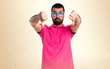 Renkli elbise koyu sarı zemin üzerine kötü sinyal yapıyor adam