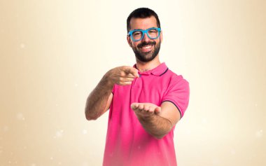 Adam bir şey Koyu sarı arka plan üzerinde tutan renkli giysileri ile