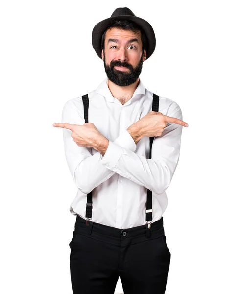 Hipster homem com barba apontando para as laterais com dúvidas — Fotografia de Stock