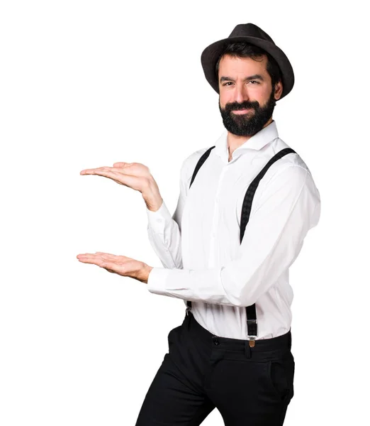 Hipster man with beard presenting something — Stock Photo, Image