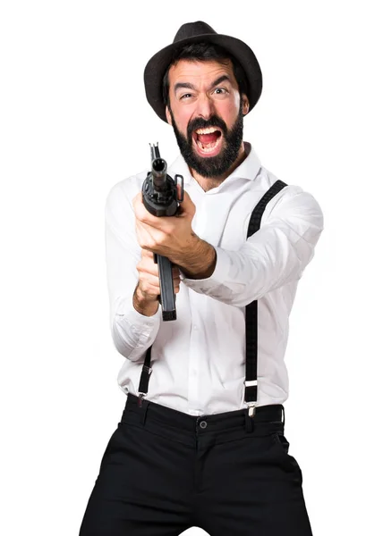 Hipster man with beard holding a rifle — Stock Photo, Image