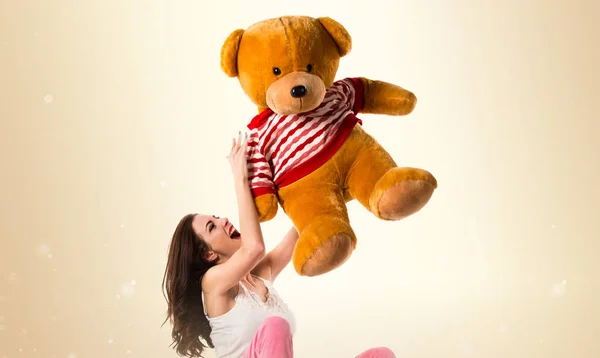 Glücklich hübsches brünettes Mädchen mit Pyjama auf ockerfarbenem Hintergrund — Stockfoto