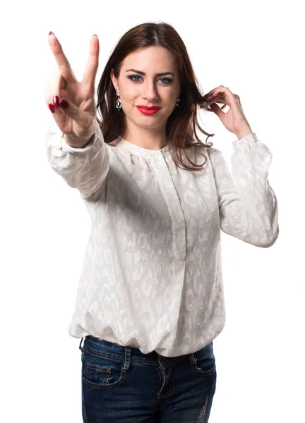 Beautiful young girl making victory gesture — Stock Photo, Image