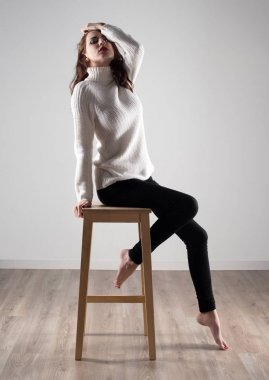 Tahta sandalyede oturan güzel model kadın