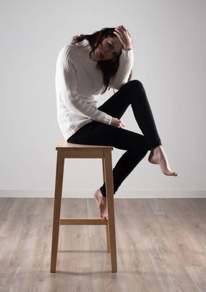 Beautiful model woman sitting on wooden chair