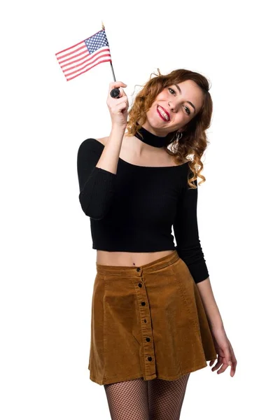 Beautiful young girl holding an american flag — Stock Photo, Image