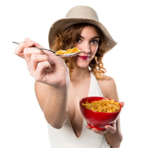 Pretty young model woman in swimsuit eating cereals from a bowl — Stock Photo, Image