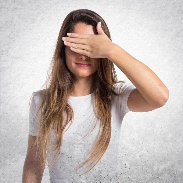 Young pretty girl covering her eyes — Stock Photo, Image