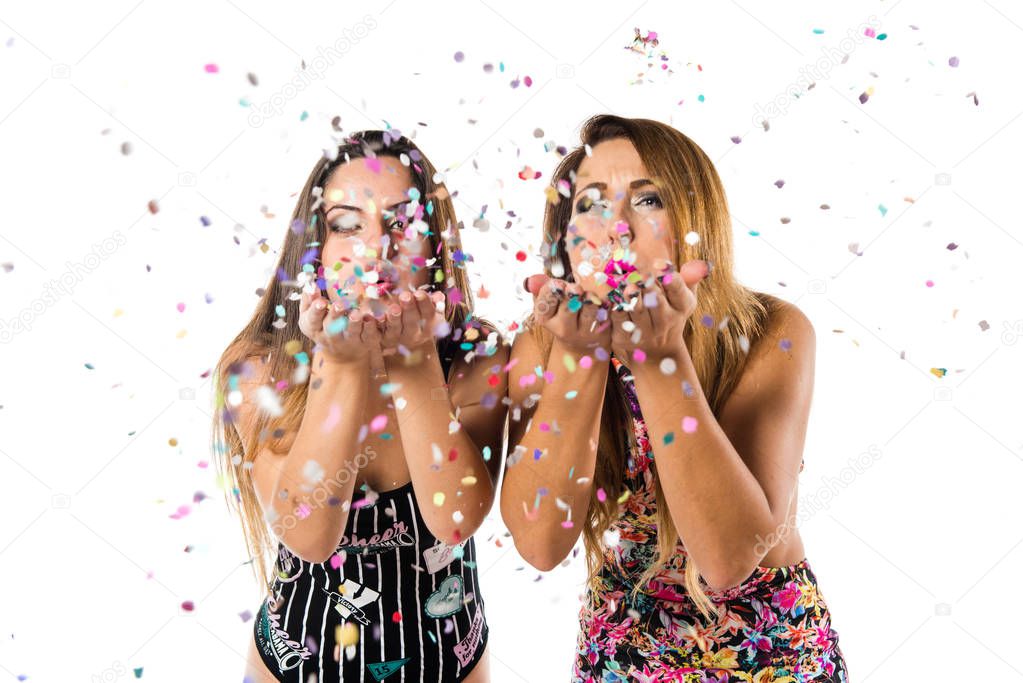 Happy young girls with confetti in a party