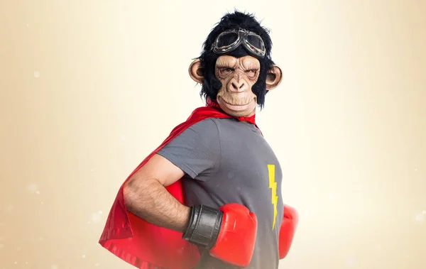 Superhero monkey man on ocher background — Stock Photo, Image