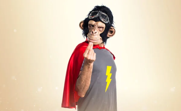 Homem macaco super-herói fazendo gesto de dinheiro em fundo ocre — Fotografia de Stock
