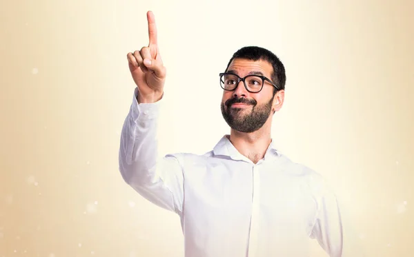 Handsome man with glasses touching on transparent screen on oche — Stock Photo, Image