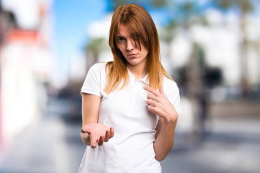 Güzel genç kız yapma sürpriz jest odaklanmamış arka plan üzerinde