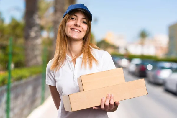 Beautiful delivery woman on unfocused background