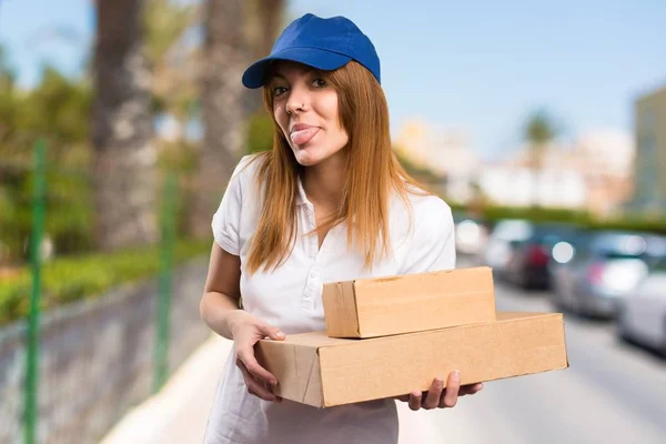 Delivery woman making a joke on unfocused background — Stock Photo, Image