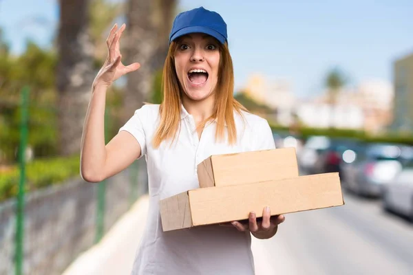 Frustrated delivery woman on unfocused background