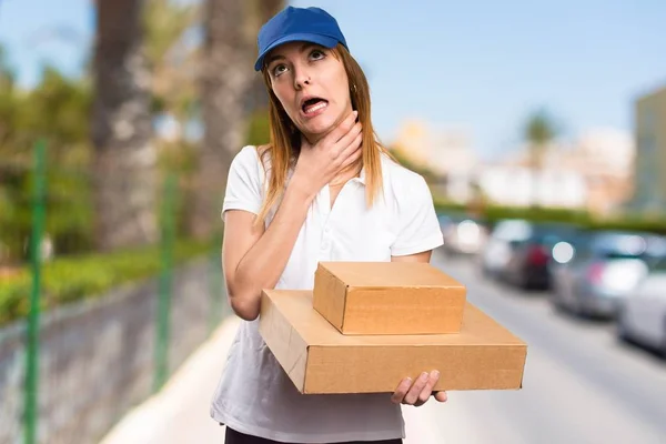 Delivery woman drowning herself on unfocused background