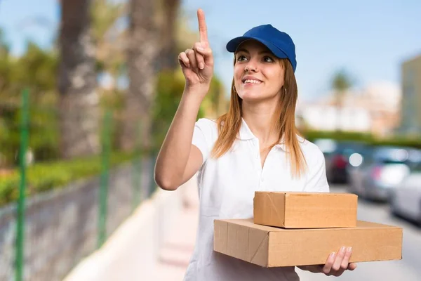 Delivery woman touching on transparent screen on unfocused background