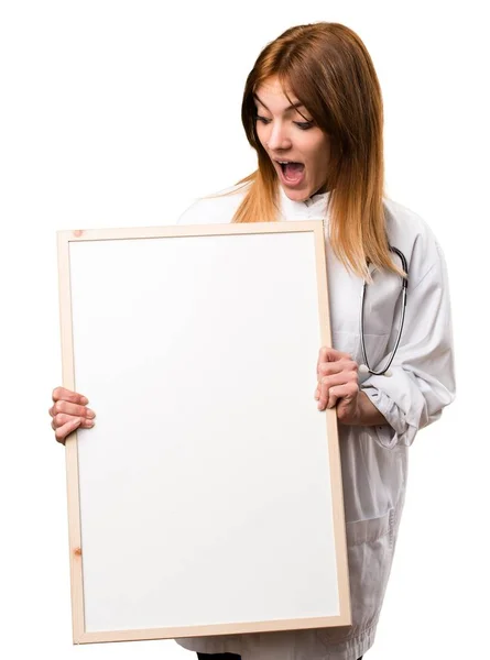 Young doctor woman holding an empty placard — Stock Photo, Image