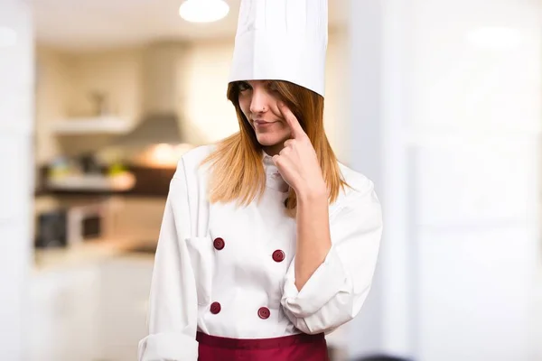 Beautiful chef woman showing something in the kitchen