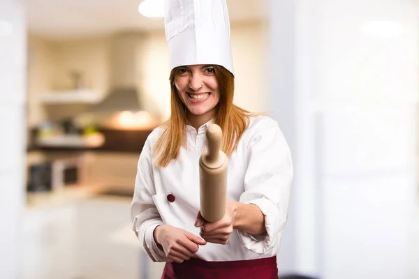 Beautiful chef woman fighting in the kitchen