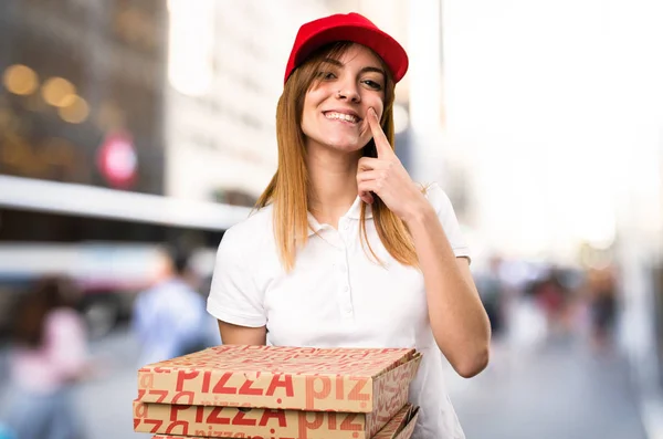 Счастливая доставщица пиццы на нефокусированном фоне — стоковое фото