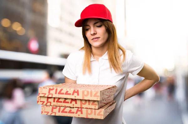 Pizza donna consegna con mal di schiena su sfondo sfocato — Foto Stock