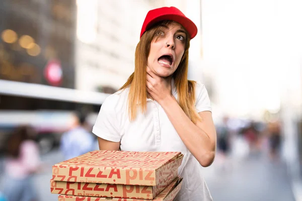 Pizza delivery woman drowning herself  on unfocused background