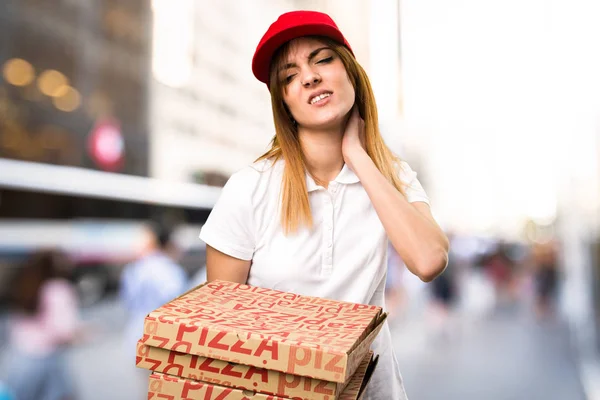 Доставка пиццы женщина с болью в шее на несосредоточенном фоне — стоковое фото