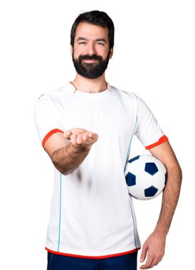 Bir şey tutan bir futbol topu futbol oyuncu