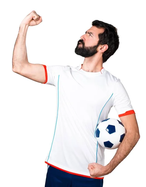 Giocatore di calcio fortunato in possesso di un pallone da calcio — Foto Stock