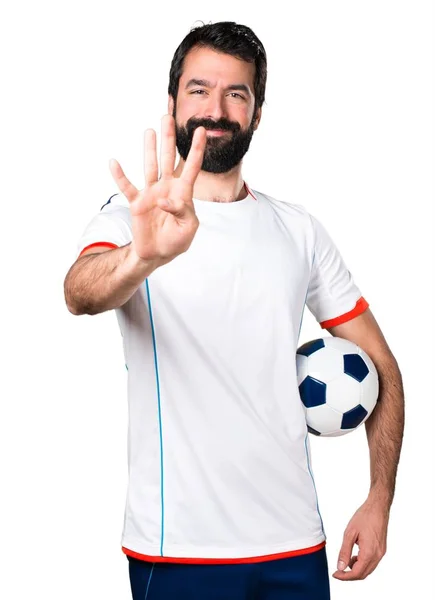 Giocatore di calcio in possesso di un pallone da calcio contare quattro — Foto Stock