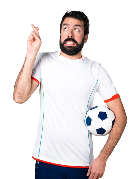 Holding egy futball-labda az átlépő ujjait labdarúgó — Stock Fotó