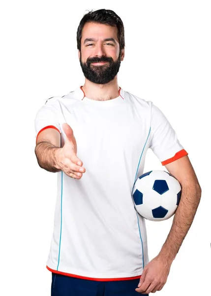 Voetbal speler bezit is van een voetbal maken een deal — Stockfoto