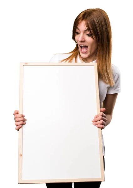 Surprised Beautiful young girl holding an empty placard — Stock Photo, Image