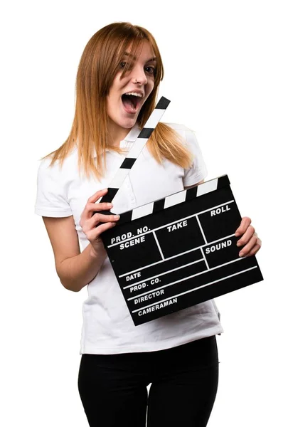Surprised Happy Beautiful young girl holding a clapperboard — Stock Photo, Image